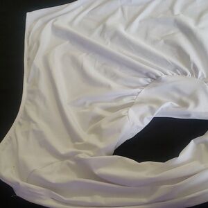 white dress with a cold shoulder and high split